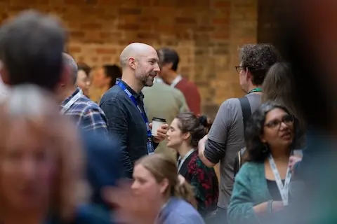Attendees chatting during a break.